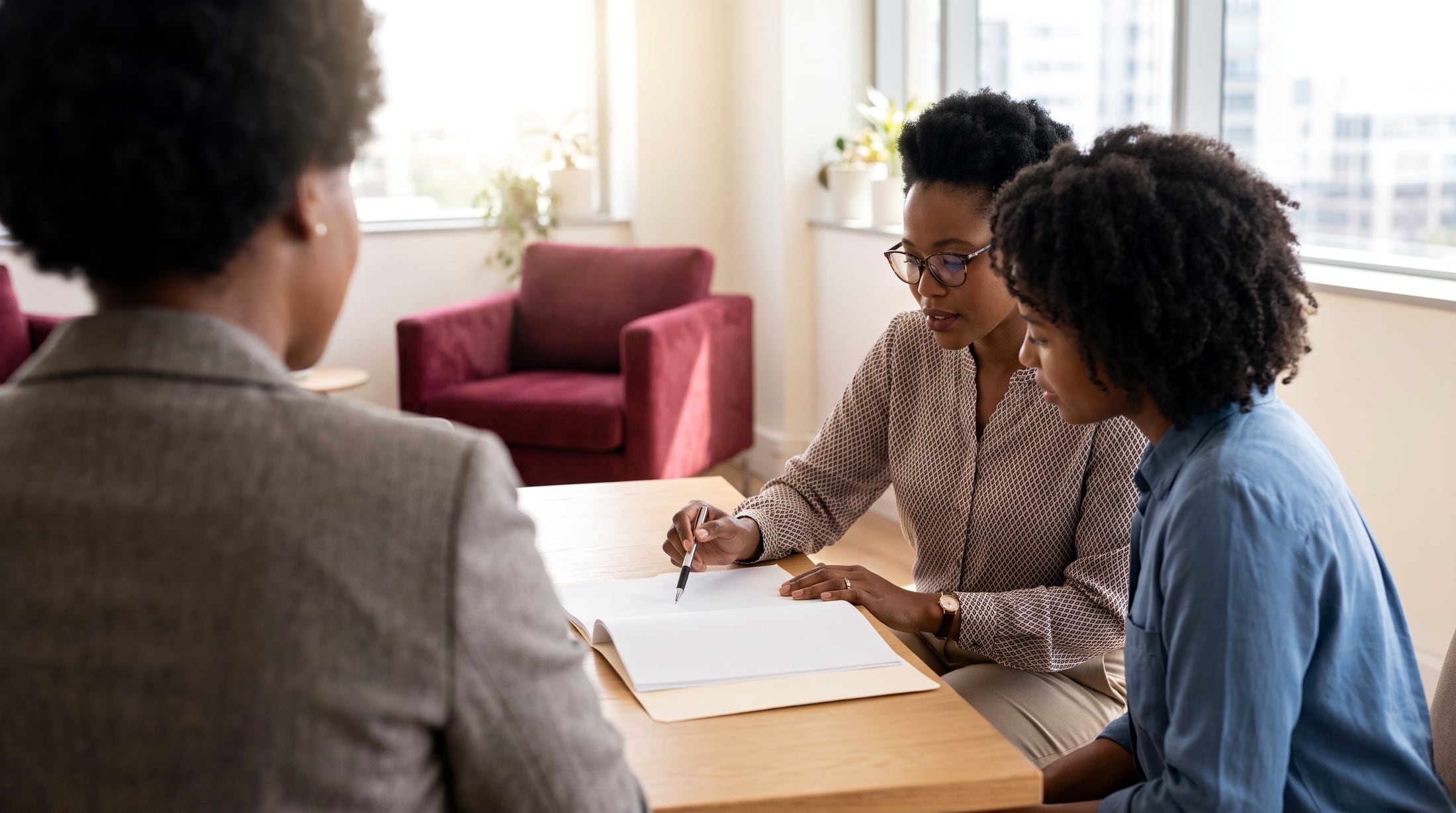 A consultant going through a file with two clients